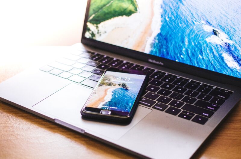 laptop and phone showing beach